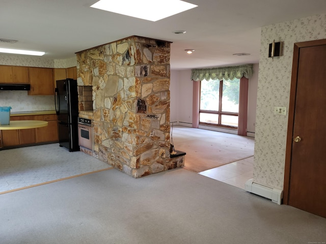 62 Rice Rd, Meriden, CT 06450 - kitchen with freestanding refrigerator, baseboard heating, under cabinet range hood, wallpapered walls, and brown cabinets