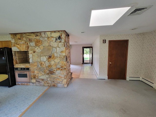 62 Rice Rd, Meriden, CT 06450 - unfurnished living room featuring a skylight, light carpet, wallpapered walls, and baseboard heating