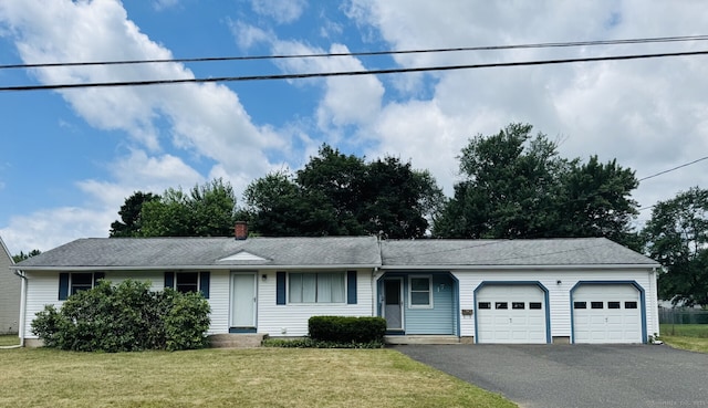 17 Marshall Dr, Enfield, CT 06082 - view of front of house featuring a garage, driveway, a front lawn, and a chimney