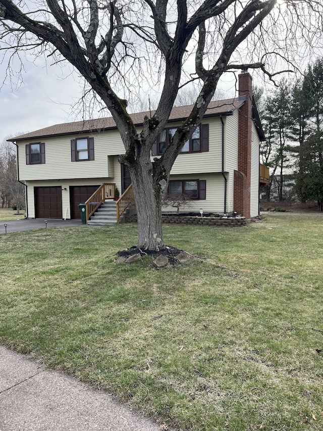 35 Depauw Cir E, Hartford, CT 06108 - bi-level home with a chimney, an attached garage, driveway, and a front lawn