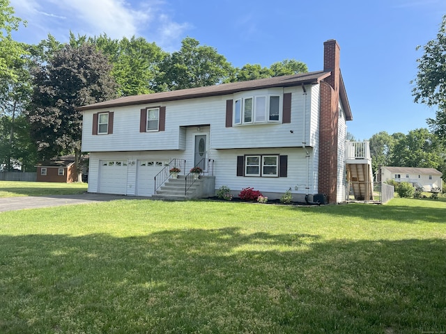 35 Depauw Cir E, Hartford, CT 06108 - split foyer home with a chimney, driveway, a garage, and a front lawn