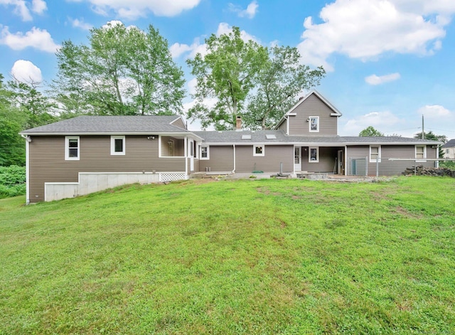 11 Harrington Rd, East Windsor, CT 06016 - back of property with a patio area, a lawn, and a chimney