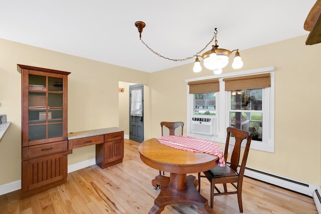 11 Harrington Rd, East Windsor, CT 06016 - dining space with a chandelier, light wood-type flooring, a baseboard radiator, and built in desk