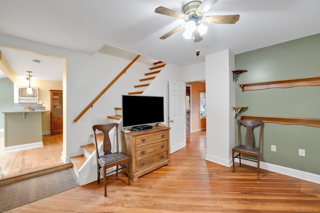 11 Harrington Rd, East Windsor, CT 06016 - living room with light wood finished floors, stairs, and ceiling fan