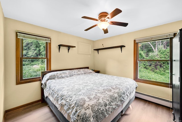 11 Harrington Rd, East Windsor, CT 06016 - bedroom featuring a baseboard heating unit, wood finished floors, and multiple windows