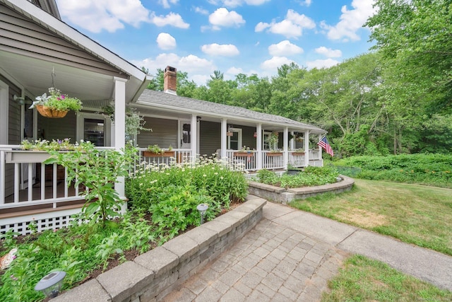 11 Harrington Rd, East Windsor, CT 06016 - entrance to property featuring covered porch, a chimney, and a lawn