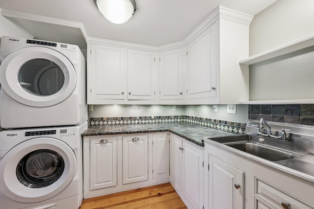 12 Jackson Rd, Killingworth, CT 06419 - laundry room featuring stacked washer / dryer, cabinet space, and light wood-style flooring