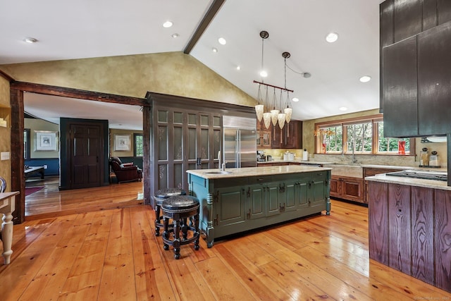 12 Jackson Rd, Killingworth, CT 06419 - kitchen with built in fridge, a center island with sink, light wood finished floors, hanging light fixtures, and high vaulted ceiling