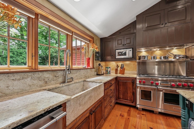 12 Jackson Rd, Killingworth, CT 06419 - kitchen featuring appliances with stainless steel finishes, lofted ceiling, tasteful backsplash, light wood-style floors, and light stone counters