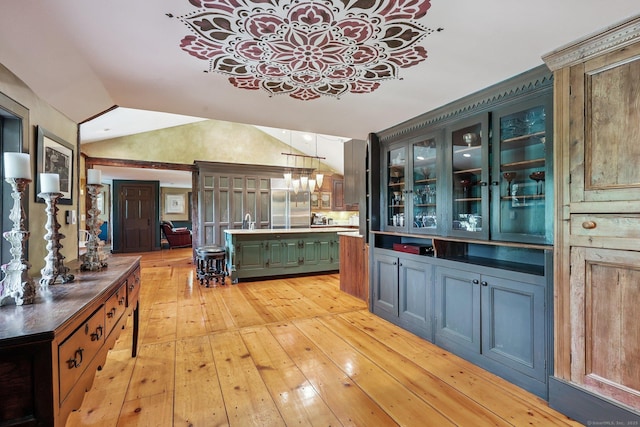 12 Jackson Rd, Killingworth, CT 06419 - bar area featuring light wood-style flooring, vaulted ceiling, stainless steel built in fridge, hanging light fixtures, and a chandelier