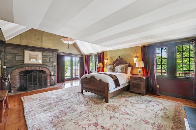 12 Jackson Rd, Killingworth, CT 06419 - bedroom featuring wood finished floors, a fireplace, vaulted ceiling, and access to outside