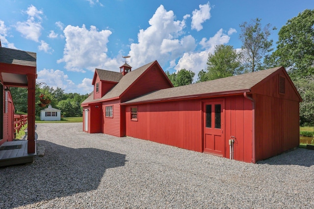12 Jackson Rd, Killingworth, CT 06419 - view of side of home featuring a shingled roof and an outdoor structure
