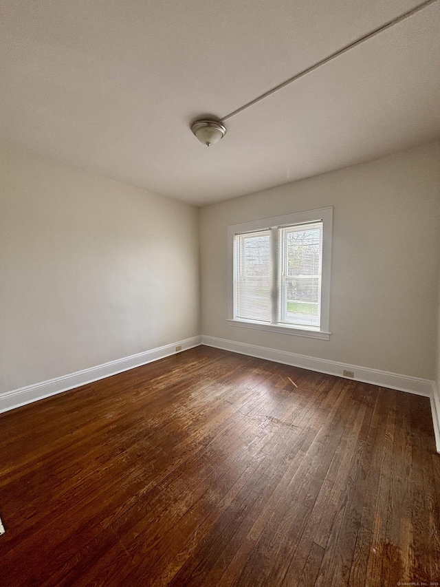 1483 Boston Ave, Bridgeport, CT 06610 - spare room featuring dark wood-style flooring and baseboards