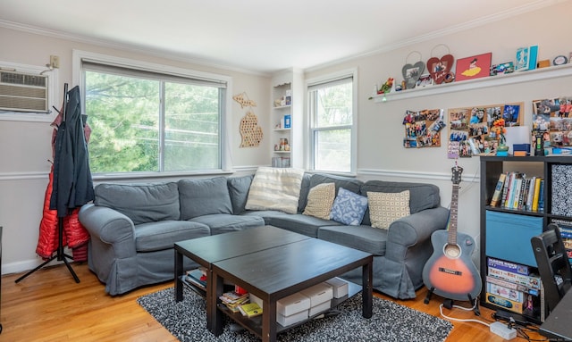 145 Quaker Ln S, West Hartford, CT 06119 - living area with crown molding, light wood-style flooring, healthy amount of natural light, and a wall unit AC