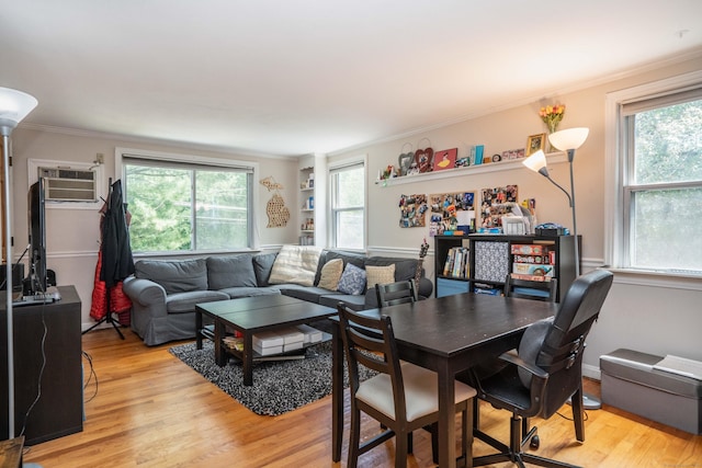 145 Quaker Ln S, West Hartford, CT 06119 - living room with light wood-type flooring, healthy amount of natural light, ornamental molding, and an AC wall unit