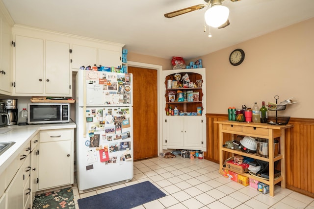 145 Quaker Ln S, West Hartford, CT 06119 - kitchen with freestanding refrigerator, stainless steel microwave, a wainscoted wall, ceiling fan, and light countertops