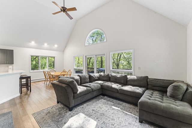 30 W Woods Rd, Burlington, CT 06013 - living room featuring high vaulted ceiling, ceiling fan, plenty of natural light, baseboard heating, and light wood-type flooring