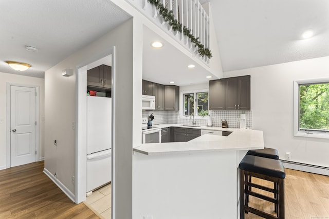 30 W Woods Rd, Burlington, CT 06013 - kitchen featuring white appliances, light countertops, light wood finished floors, tasteful backsplash, and recessed lighting