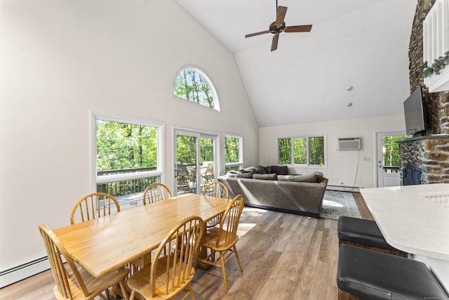 30 W Woods Rd, Burlington, CT 06013 - dining space with high vaulted ceiling, a stone fireplace, light wood-style flooring, ceiling fan, and baseboard heating