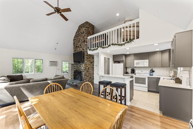 30 W Woods Rd, Burlington, CT 06013 - dining area featuring high vaulted ceiling, a ceiling fan, a wall unit AC, a stone fireplace, and recessed lighting