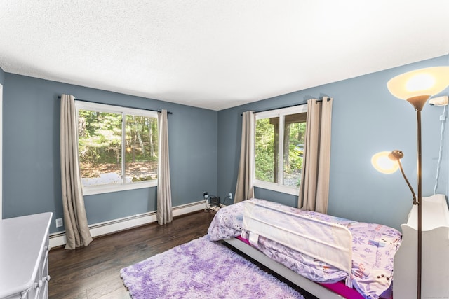30 W Woods Rd, Burlington, CT 06013 - bedroom with multiple windows, dark wood-style floors, a baseboard radiator, and a textured ceiling