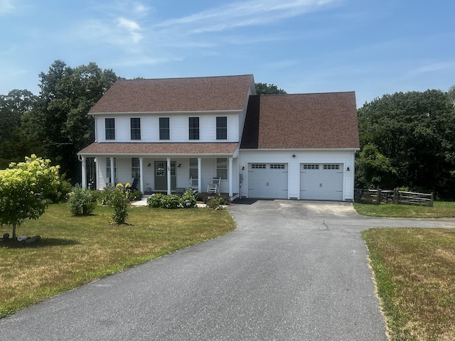 25 Quakertown Mdw, Ledyard, CT 06339 - colonial house featuring a porch, a garage, driveway, and a shingled roof