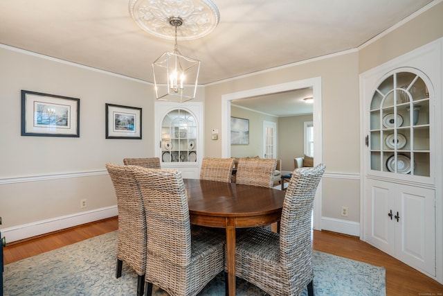 169 Brace Rd, West Hartford, CT 06107 - dining space featuring wood finished floors, a chandelier, and crown molding