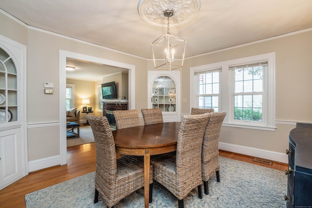 169 Brace Rd, West Hartford, CT 06107 - dining space featuring a chandelier, wood finished floors, plenty of natural light, and ornamental molding