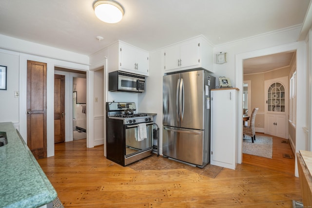 169 Brace Rd, West Hartford, CT 06107 - kitchen with appliances with stainless steel finishes, light wood-style flooring, white cabinets, ornamental molding, and light countertops