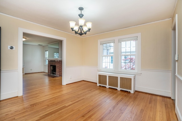 169 Brace Rd, West Hartford, CT 06107 - unfurnished dining area featuring radiator heating unit, a chandelier, plenty of natural light, light wood-type flooring, and ornamental molding