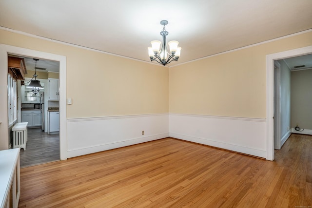 169 Brace Rd, West Hartford, CT 06107 - unfurnished room featuring a chandelier, crown molding, and light wood-style flooring