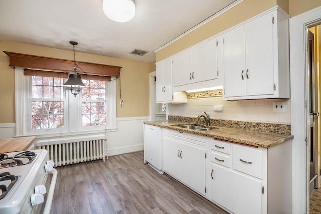 169 Brace Rd, West Hartford, CT 06107 - kitchen featuring radiator, white cabinets, tasteful backsplash, white appliances, and light wood-style flooring