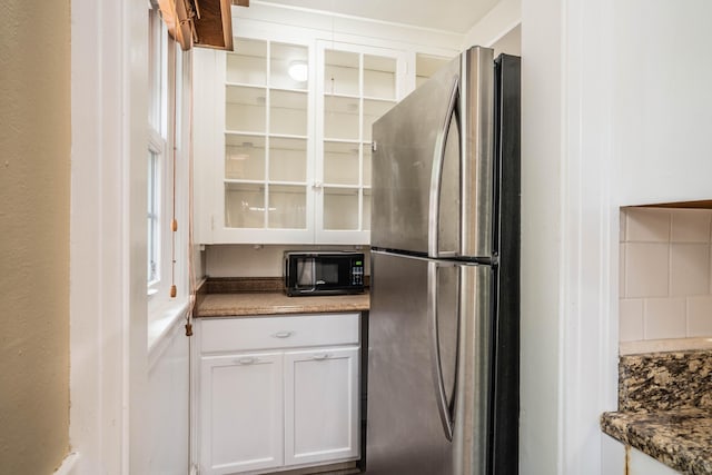 169 Brace Rd, West Hartford, CT 06107 - kitchen featuring freestanding refrigerator, black microwave, and white cabinets