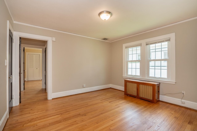 169 Brace Rd, West Hartford, CT 06107 - spare room featuring radiator heating unit, crown molding, and light wood-type flooring