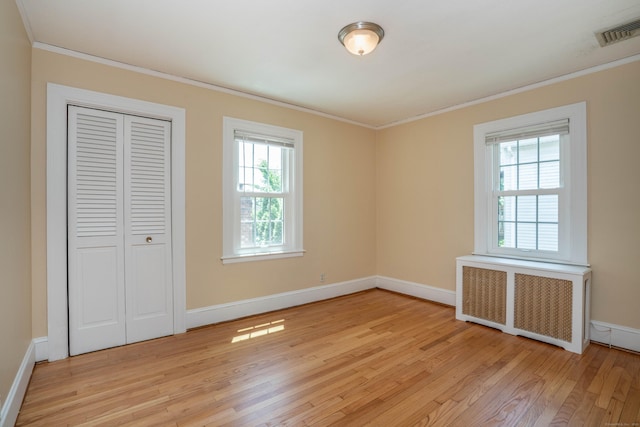 169 Brace Rd, West Hartford, CT 06107 - unfurnished bedroom featuring radiator heating unit, ornamental molding, light wood-style floors, and a closet