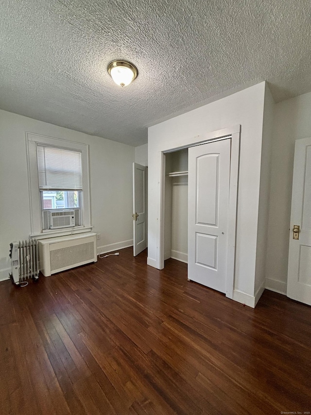 138 Mill Hill Ave, Bridgeport, CT 06610 - unfurnished bedroom with radiator heating unit, wood finished floors, cooling unit, a closet, and a textured ceiling
