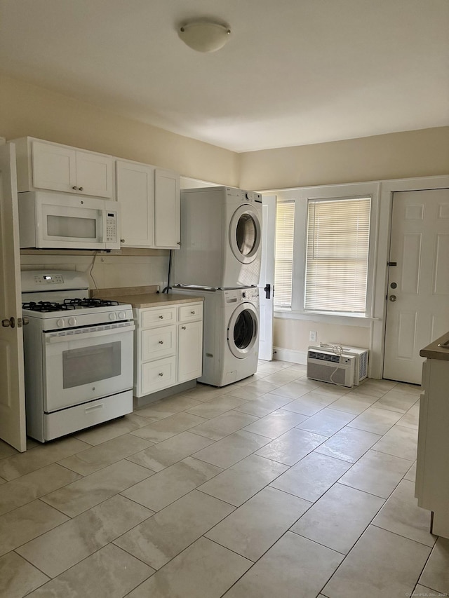 138 Mill Hill Ave, Bridgeport, CT 06610 - kitchen with white appliances, stacked washer / drying machine, white cabinetry, and light tile patterned floors