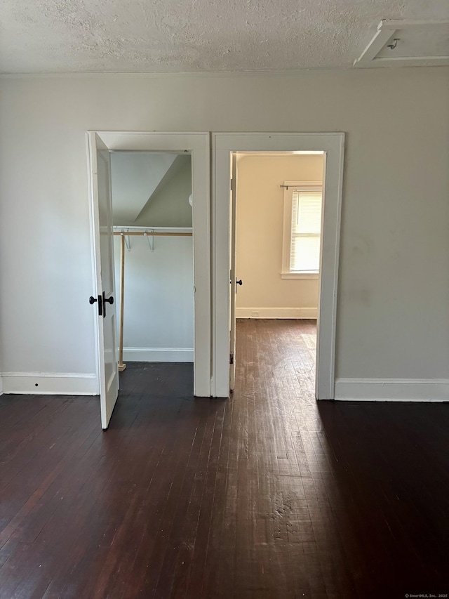 138 Mill Hill Ave, Bridgeport, CT 06610 - unfurnished bedroom featuring dark wood-type flooring, a textured ceiling, and a closet