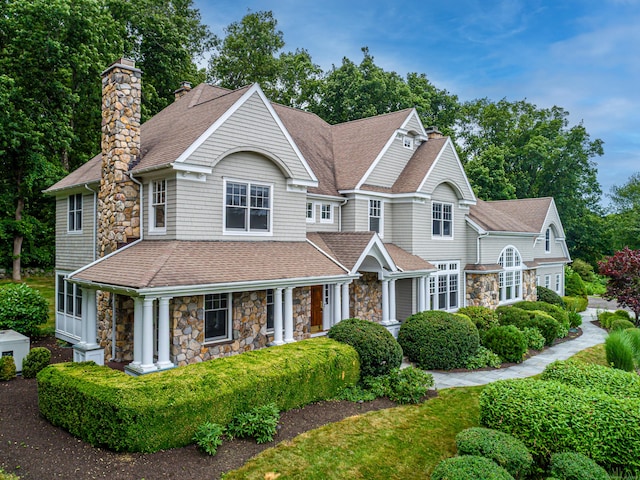 125 Nod Hill Rd, Wilton, CT 06897 - shingle-style home with stone siding, a chimney, a shingled roof, and covered porch