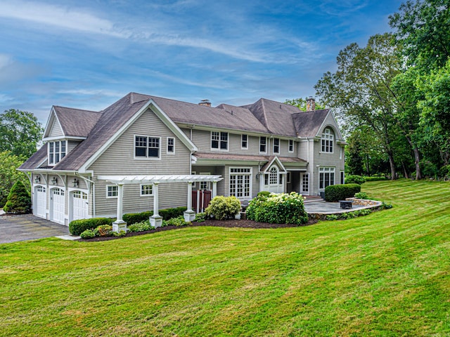 125 Nod Hill Rd, Wilton, CT 06897 - view of front facade featuring asphalt driveway, a pergola, a front lawn, a garage, and a chimney
