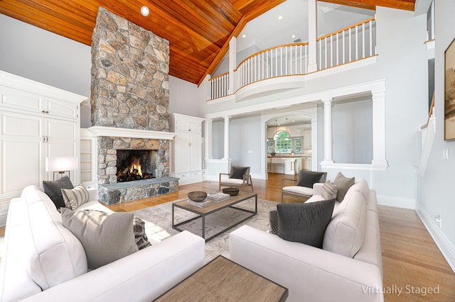 125 Nod Hill Rd, Wilton, CT 06897 - living area with wood ceiling, high vaulted ceiling, decorative columns, a fireplace, and wood finished floors