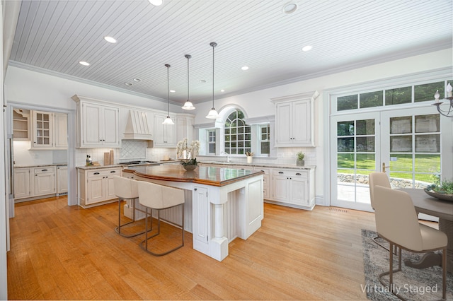 125 Nod Hill Rd, Wilton, CT 06897 - kitchen with a kitchen island, butcher block counters, light wood-style floors, stainless steel gas stovetop, and recessed lighting