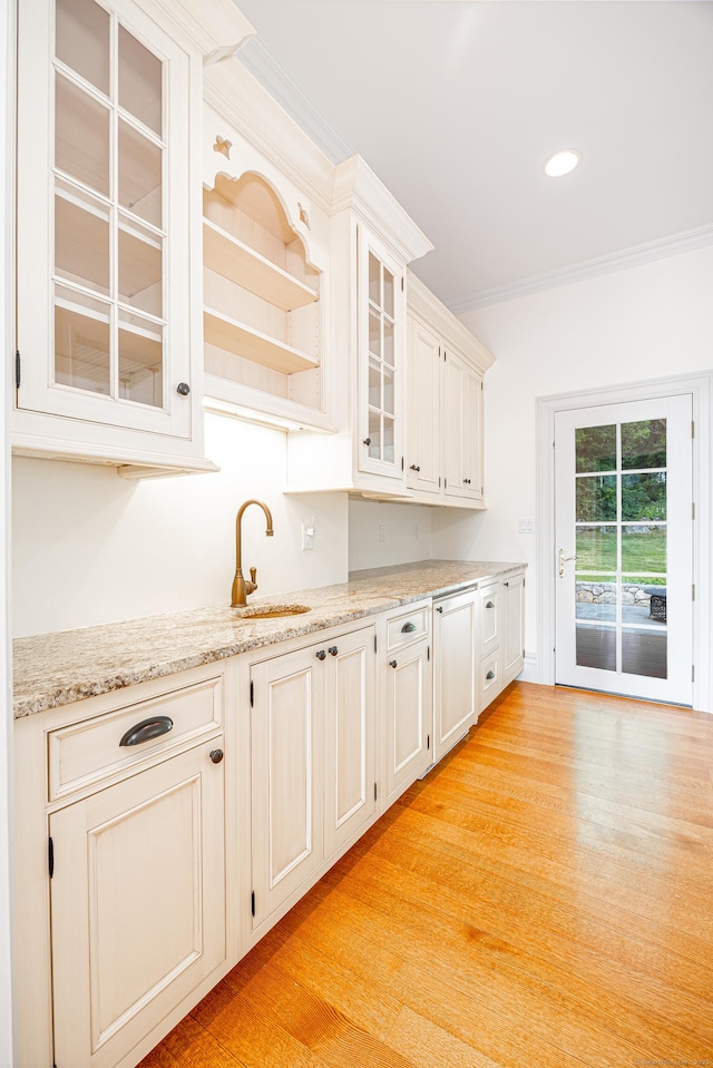 125 Nod Hill Rd, Wilton, CT 06897 - kitchen featuring glass insert cabinets, light wood-style flooring, ornamental molding, light stone countertops, and recessed lighting