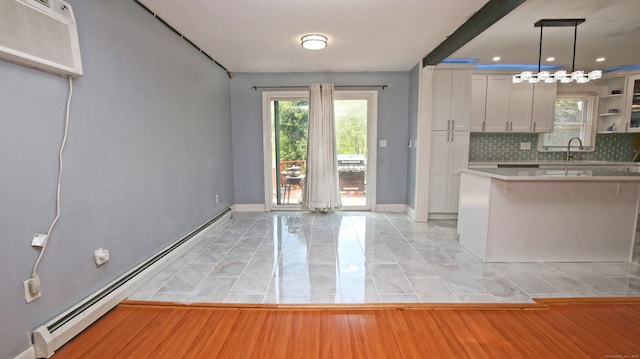 425 Scott Rd, Waterbury, CT 06705 - kitchen with a baseboard radiator, backsplash, an AC wall unit, light countertops, and a kitchen bar