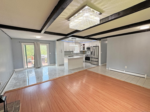 425 Scott Rd, Waterbury, CT 06705 - unfurnished living room with a baseboard heating unit, a chandelier, light tile patterned flooring, beamed ceiling, and a textured ceiling