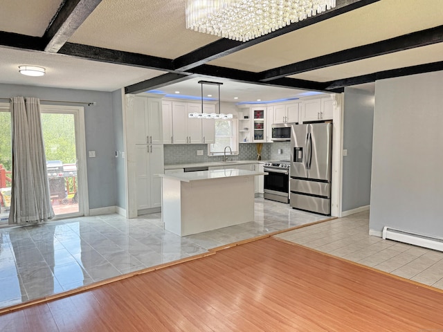 425 Scott Rd, Waterbury, CT 06705 - kitchen with appliances with stainless steel finishes, light countertops, backsplash, white cabinets, and beam ceiling