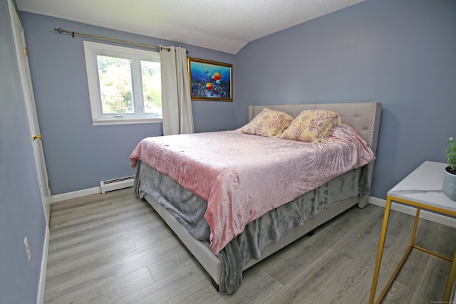 425 Scott Rd, Waterbury, CT 06705 - bedroom with a baseboard heating unit, wood finished floors, and lofted ceiling