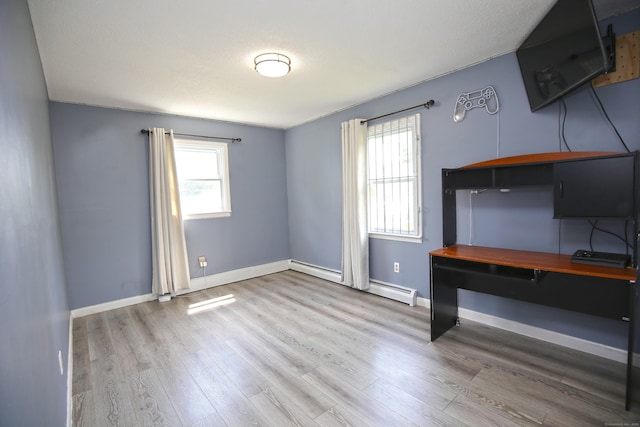 425 Scott Rd, Waterbury, CT 06705 - unfurnished office with wood finished floors and a baseboard heating unit