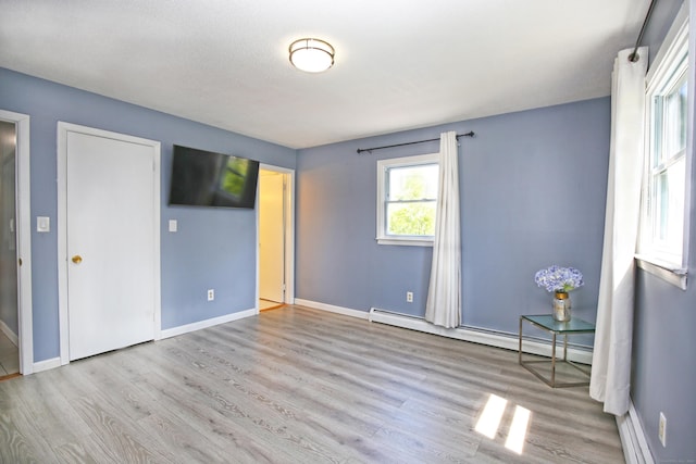 425 Scott Rd, Waterbury, CT 06705 - unfurnished bedroom featuring a baseboard heating unit and wood finished floors