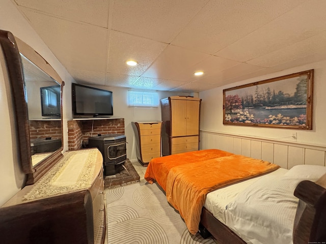 425 Scott Rd, Waterbury, CT 06705 - bedroom featuring a wood stove, a wainscoted wall, a drop ceiling, and recessed lighting